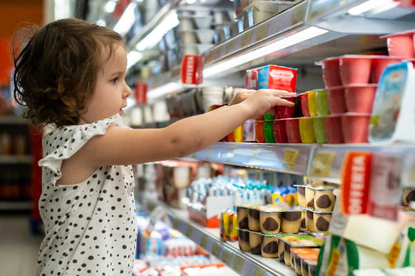 child reaching for dairy product