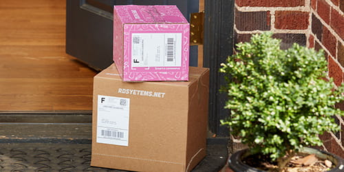 Paperboard E-commerce packages on front steps of house