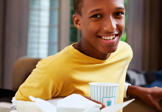 Kid enjoying foodservice drink cup and takeout container