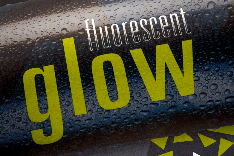 A close up of a black and yellow fluorescent glow beverage package.